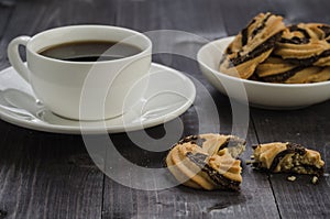 White cup of coffee and cookies/white cup of coffee and cookies on a wooden dark table