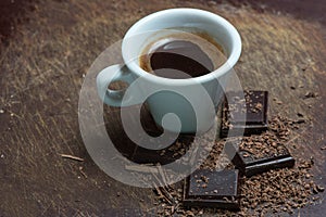 White cup of coffee and dark chocolate
