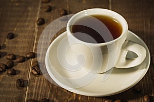 white cup from coffee on a dark wooden background/white cup from