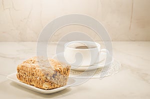white cup of coffee and dessert/white coffee cup and biscuit on a white marble  background. Selective focus