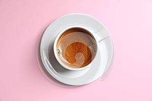 White cup of coffee espresso on pink background