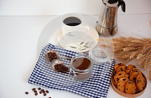 White cup of coffee and homemade round cookies with chocolate chips. Breakfast is on the table. Food at home. Still life. Coffee