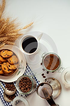 White cup of coffee and homemade round cookies with chocolate chips. Breakfast is on the table. Food at home. Still life. Coffee