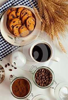 White cup of coffee and homemade round cookies with chocolate chips. Breakfast is on the table. Food at home. Still life. Coffee