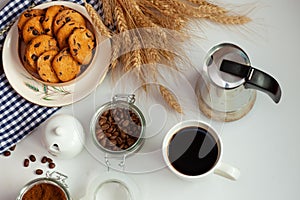 White cup of coffee and homemade round cookies with chocolate chips. Breakfast is on the table. Food at home. Still life. Coffee