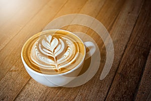 A white cup of coffee latte or cappuccino art