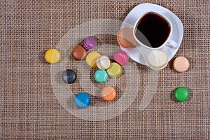 A white cup of coffee and macaroons