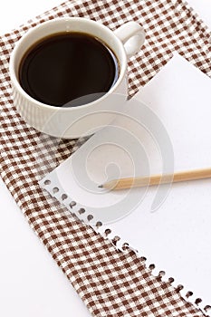 White cup coffee with notepad and pencil
