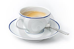 White cup of coffee on plate with spoon