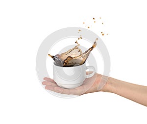White cup with coffee splas  in the womens hand photo