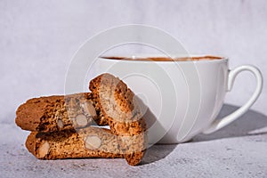 White cup of coffee and traditional homemade italian cantuccini cookies. Biscotti Cantuccini Cookie Biscuits with
