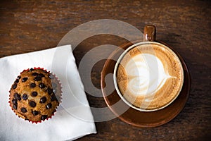 White cup of coffee on vintage wood. Top view , cup on wooden ta