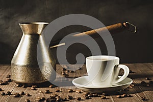 white cup and the coffeemaker with hot steam on a wooden background/white cup and the coffeemaker with hot steam on a wooden back