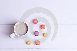 White Cup of fragrant cappuccino with macaroni cakes on white background