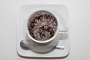 White cup full on coffee beans