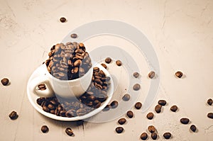 white cup full of coffee beans/white cup full of coffee beans. Copy space