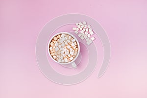 White Cup of Hot Chocolate Cocoa with Marshmellows on Pink Background Marshmellow are Lying on Pin Background Top View Horizontal