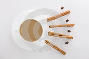 White cup of hot coffee and Cinnamon sticks
