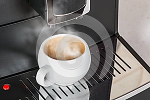 White Cup with hot cooked on the expresso coffee machine