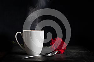 White Cup with Hot Steaming Drink and Flower