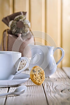 White cup and jug with bag on table