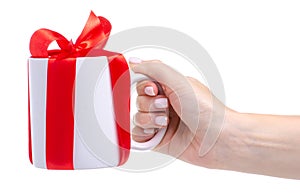 White cup mug with red ribbon bow gift in hand