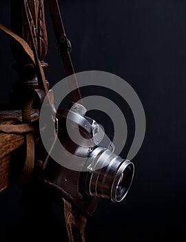 White cup on the old armchair with scarf  in dark key close up