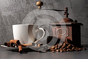 White cup and old coffee grinder