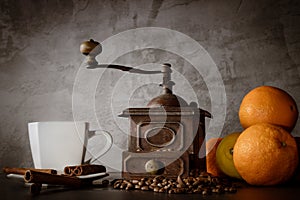 White cup and old coffee grinder