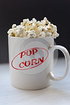 White cup with popcorn.