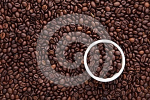 white cup of roasted coffee bean on top of flat lay of brown roasted coffee bean can be used as a background