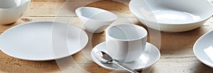 White cup on saucer and ceramic bowls