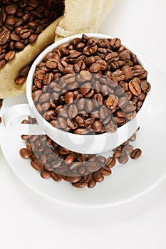 White cup and saucer with coffee crop