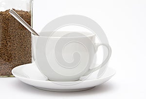 White cup and saucer with spoon