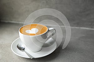 White cup of tasty cappuccino with love art latte