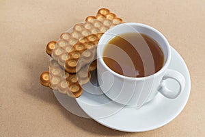 White cup of tea with biscuits