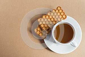 White cup of tea with biscuits