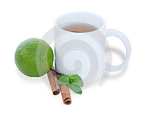 White cup of tea with lime, cinnamon and mint