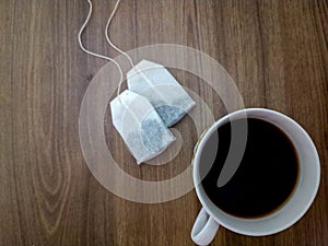 white cup of tea and tea bag on a wooden table ,isolated