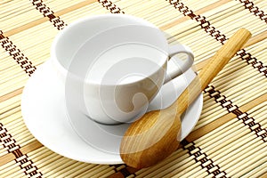 White cup with wooden spoon