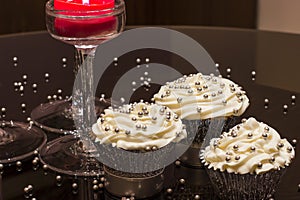 White cupcakes with silver sprinkles