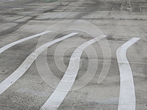 white curling stripes painted on a concrete sport floor