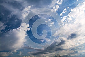 White curly clouds in a blue sky. Sky background.