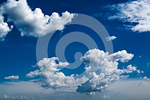 White curly clouds in a blue sky. Sky background,