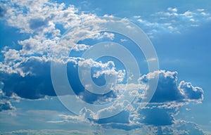 White curly clouds in a blue sky. Sky background.