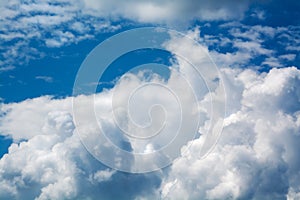 White curly clouds in a blue sky. Sky background.