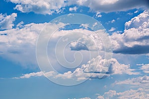 White curly clouds in a blue sky. Sky background,