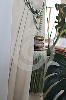 White curtain with rope tassel. Hanging window curtain decoration. Luxury cornice decoration