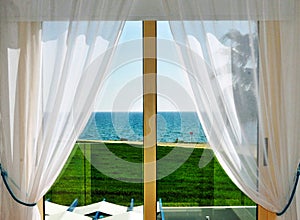 White Curtains and Window with Sea View