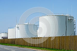 White cylindrical storage tanks for petroleum products